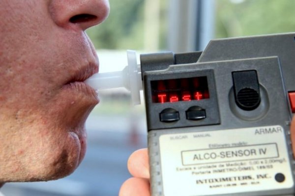 Motorista passando por teste do bafômetro para fiscalização do consumo de álcool