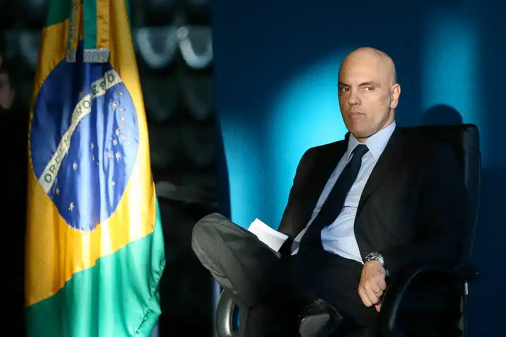 Ministro do STF Alexandre de Moraes ao lado da bandeira do Brasil