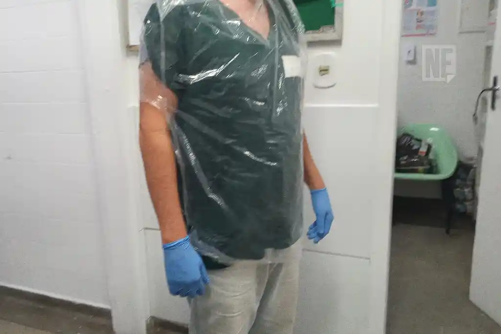 Servidor da Saúde de Sergipe usando saco de lixo para improvisar a proteção e conseguir trabalhar no Huse