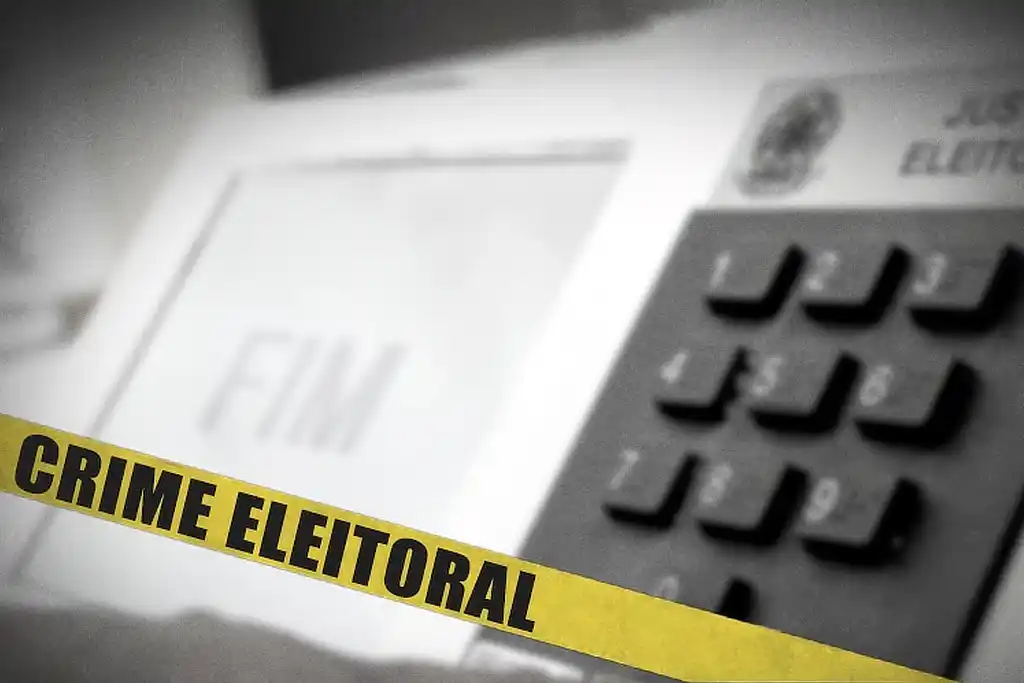Imagem da urna eletrônica com uma faixa amarela a frente com os dizeres 'crime eleitoral'